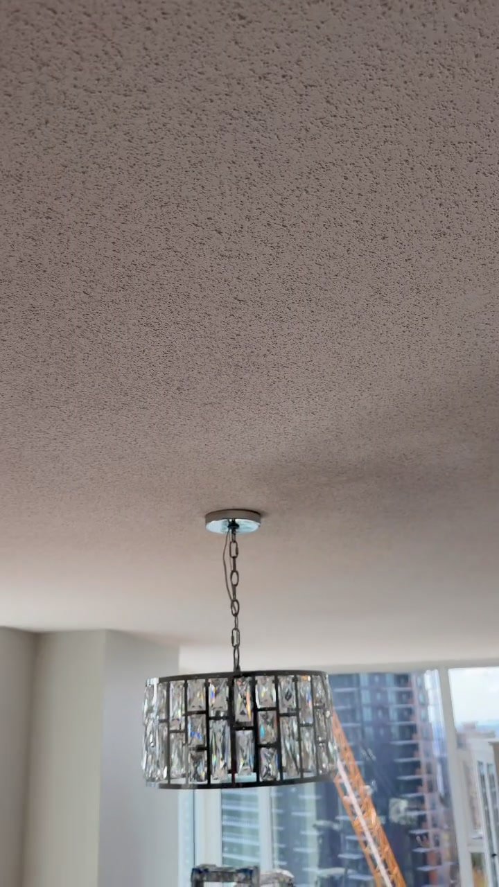 Painter rolling fresh paint on ceiling