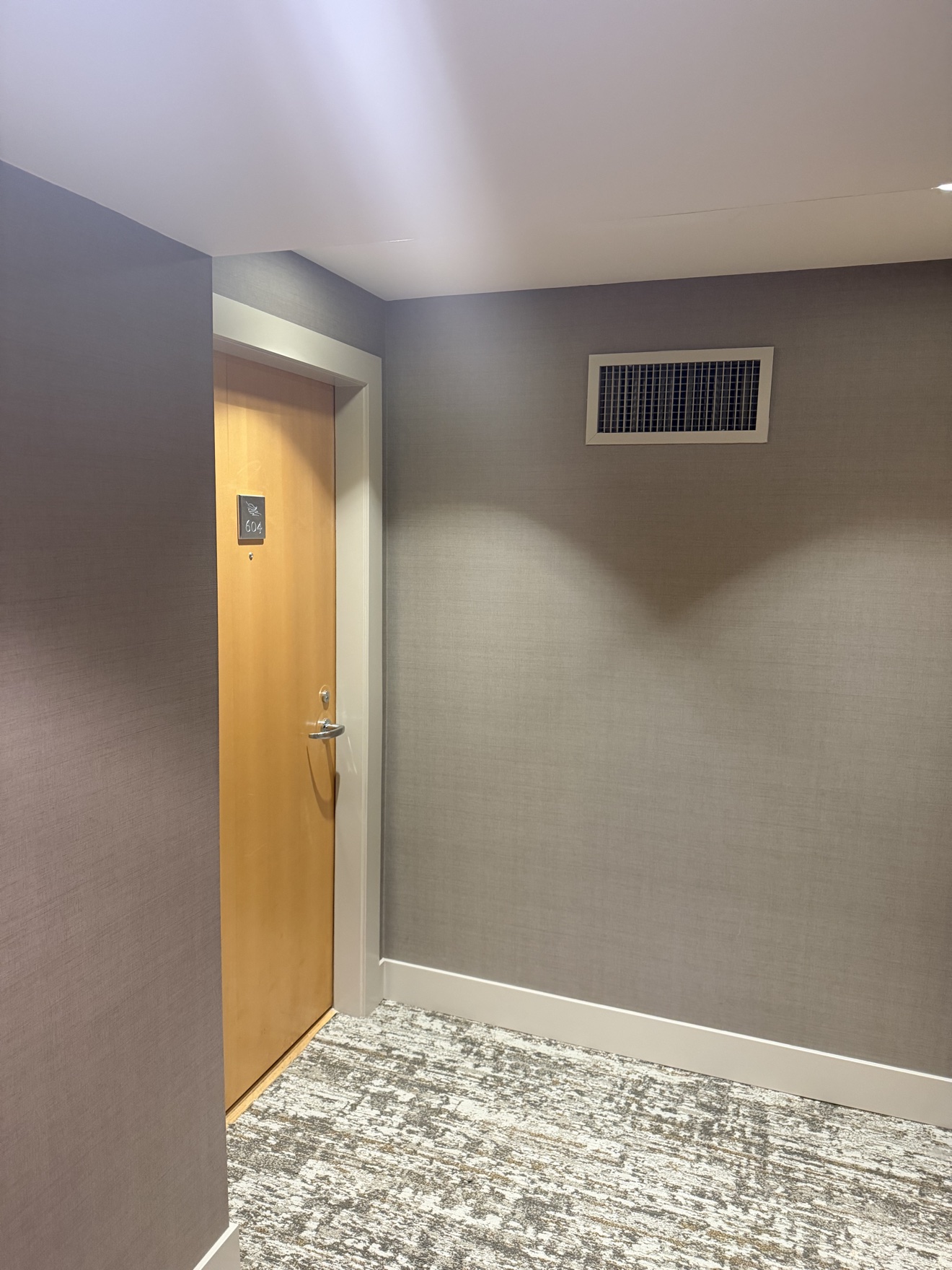 Hallway mid-prep with walls stripped — Bayshore Towers repaint