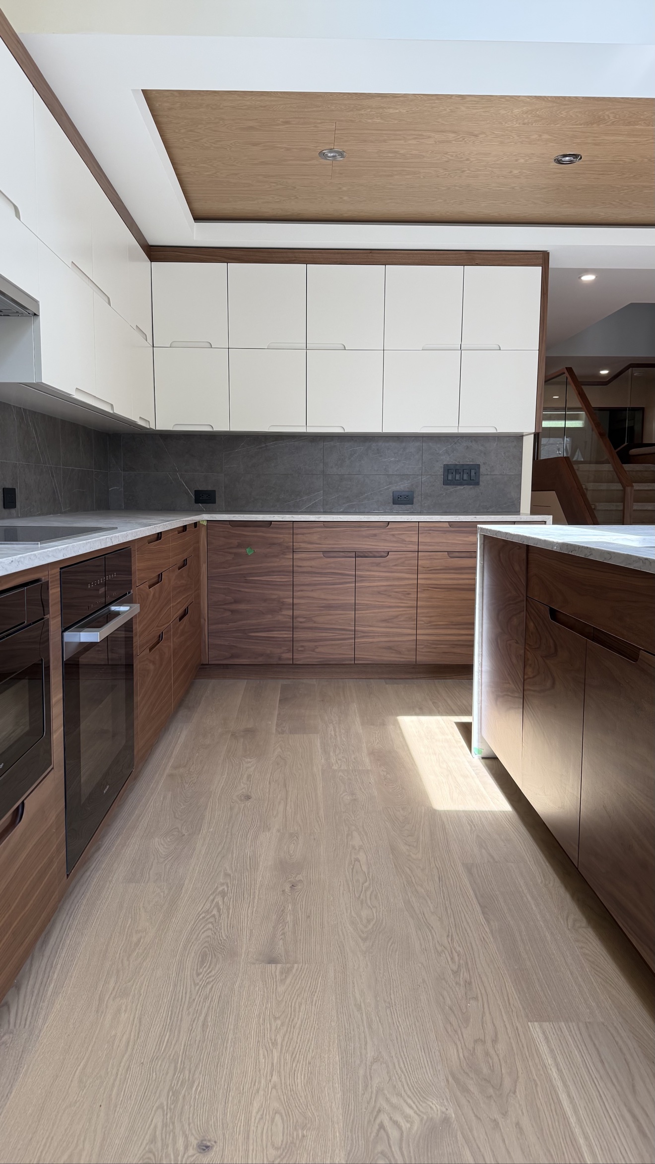 Refinished wood kitchen cabinets by Exceptional Painting