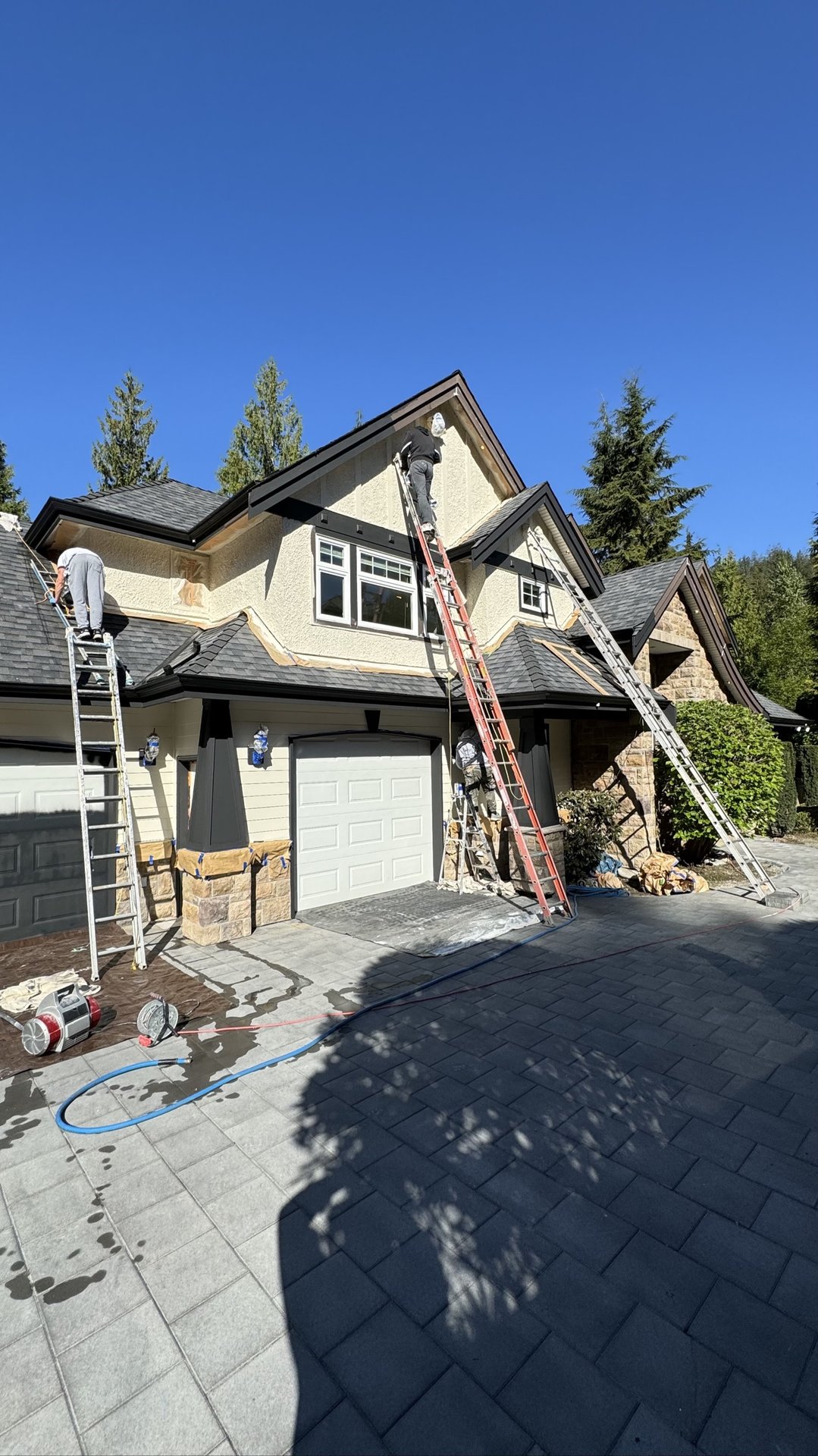 Painting crew refreshing an older home exterior in Delta