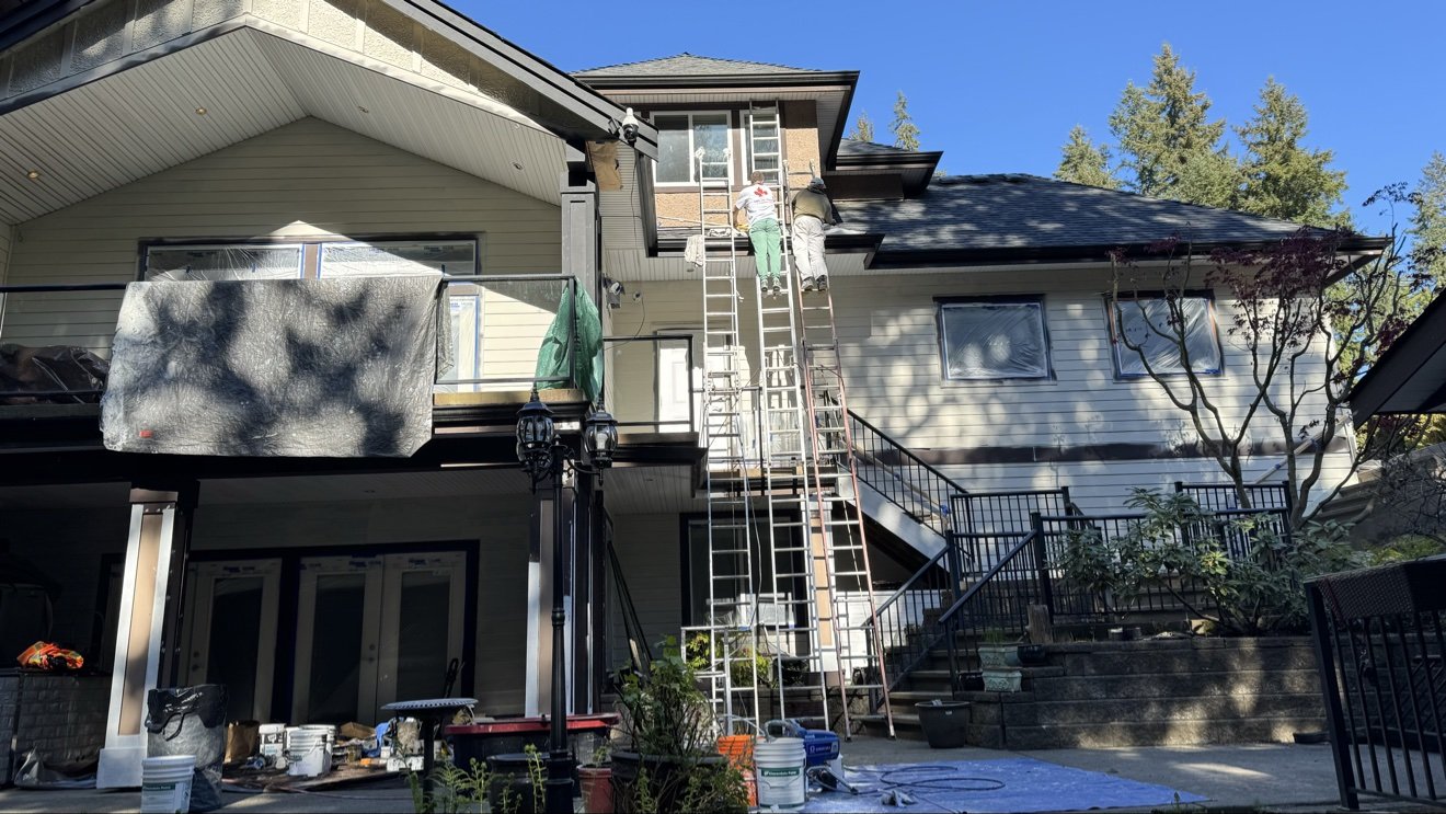 Exceptional Painting crew on ladders painting a house exterior in Metro Vancouver