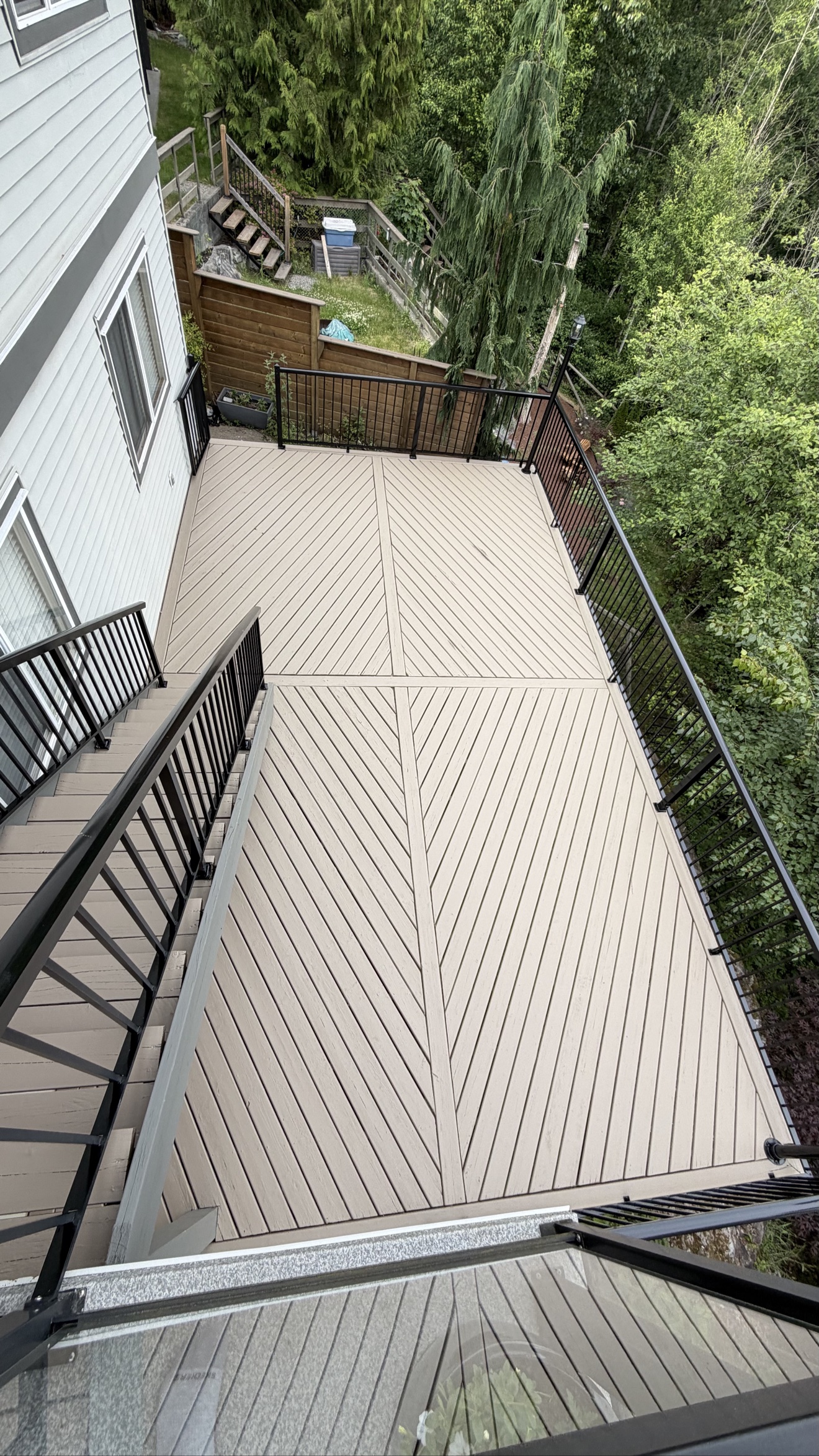 Finished deck with black railings by Exceptional Painting