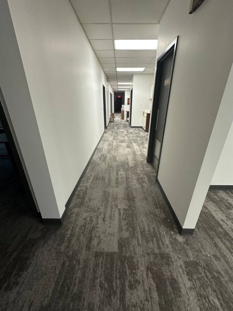 Freshly repainted office hallway with new flooring by Exceptional Painting